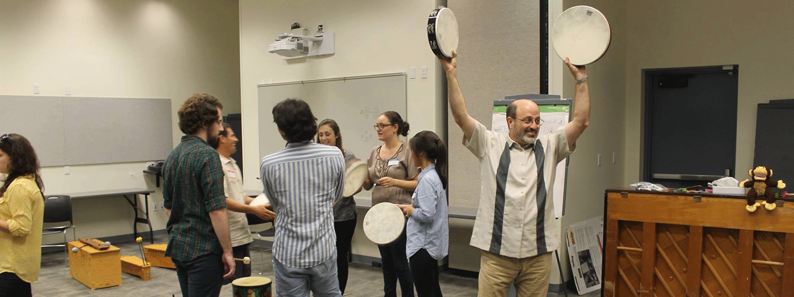 Dr. Robert Amchin teaching Orff music to a roomful of music education students.